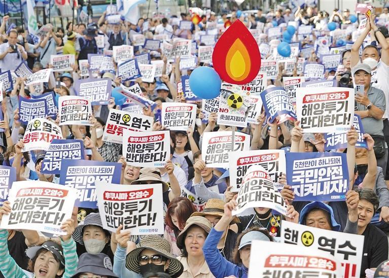 圖為7月1日，民眾手持“反對向海洋排放福島核污染水”等字樣的標語在韓國首爾參加集會。新華社發（李相浩 攝）